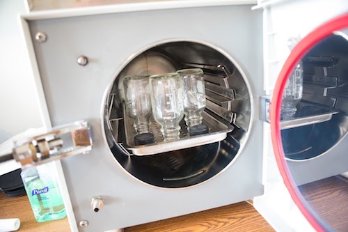 Autoclave with reusable glass bottles.